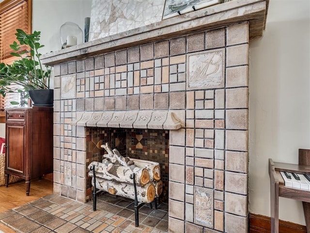 interior details with wood finished floors and a fireplace
