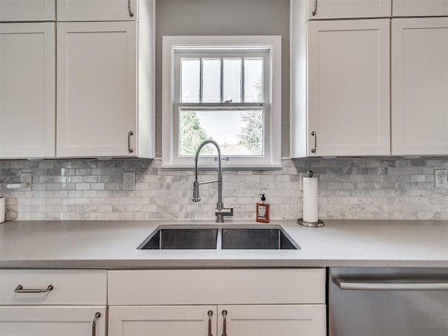 kitchen featuring a sink, white cabinetry, and dishwasher