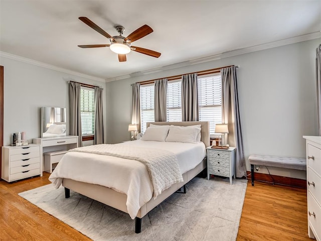 bedroom featuring ceiling fan, ornamental molding, and light wood finished floors
