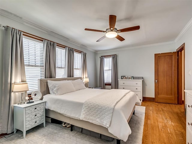 bedroom featuring crown molding, baseboards, ceiling fan, and light wood-style floors
