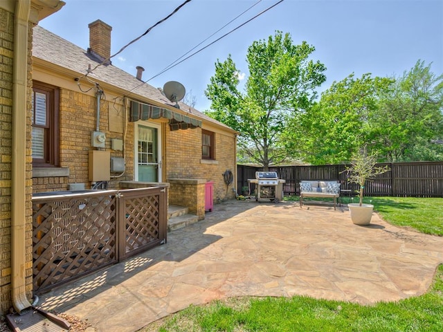 view of patio / terrace with an outdoor hangout area, a fenced backyard, and a grill