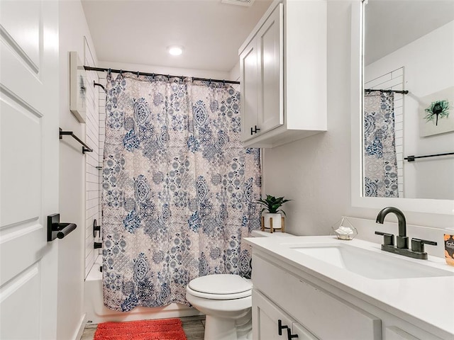 full bathroom featuring shower / bath combo, vanity, toilet, recessed lighting, and wood finished floors