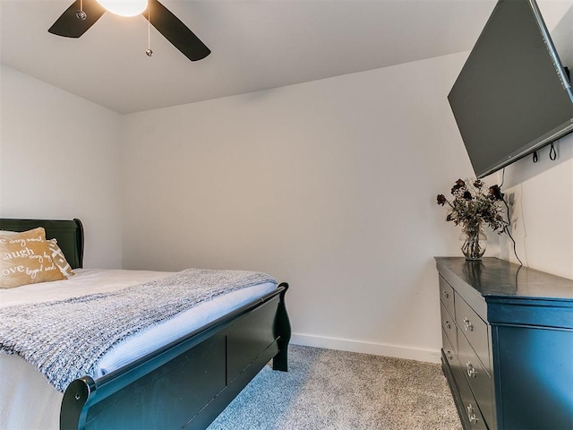 bedroom with baseboards, ceiling fan, and light colored carpet