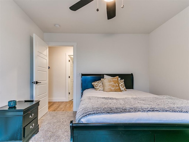 bedroom with baseboards, ceiling fan, and wood finished floors
