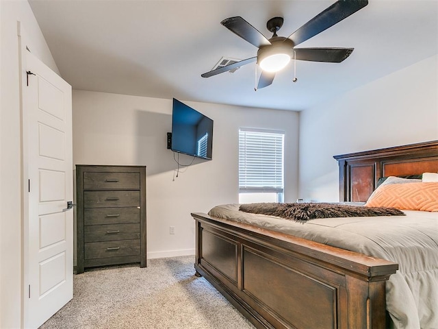 bedroom featuring baseboards, light carpet, a ceiling fan, and visible vents