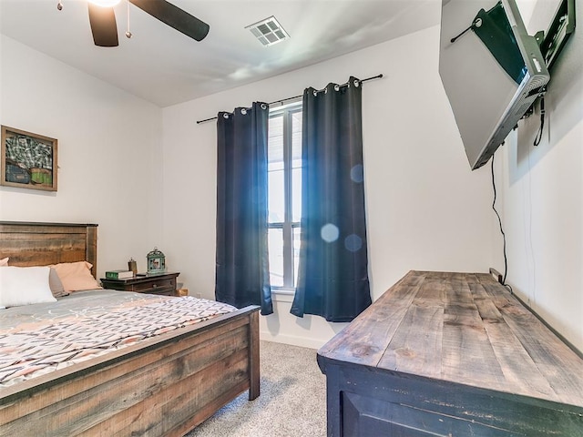 carpeted bedroom featuring ceiling fan and visible vents