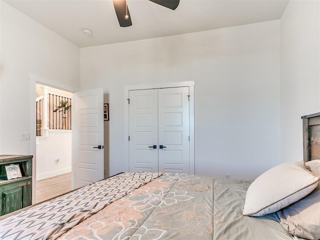 bedroom with ceiling fan, a closet, and wood finished floors