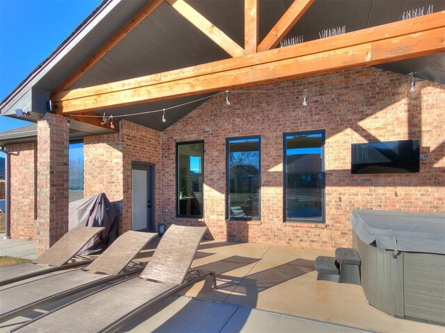 exterior space with a hot tub