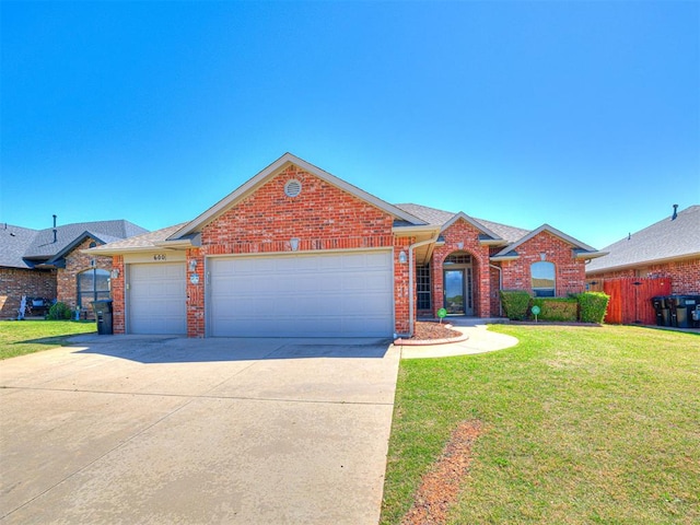 view of front of home with brick siding, driveway, a front lawn, and a garage