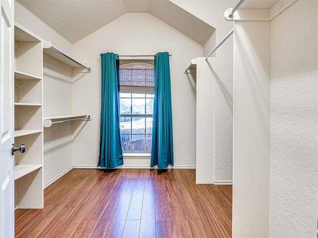 spacious closet featuring wood finished floors and lofted ceiling