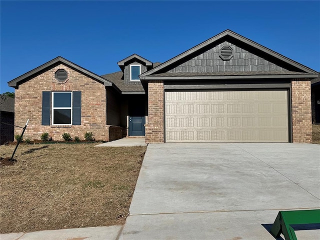 437 Kale Rd, Tuttle, OK 73089 - ranch-style home with brick siding, driveway, a garage, and a front lawn