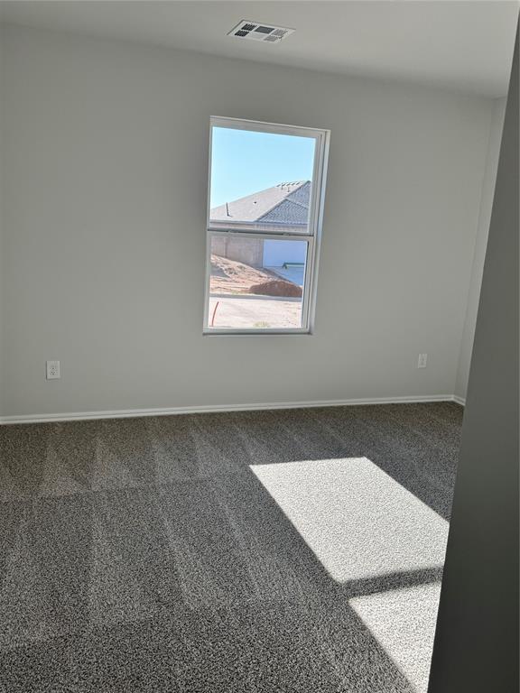 437 Kale Rd, Tuttle, OK 73089 - carpeted spare room with baseboards