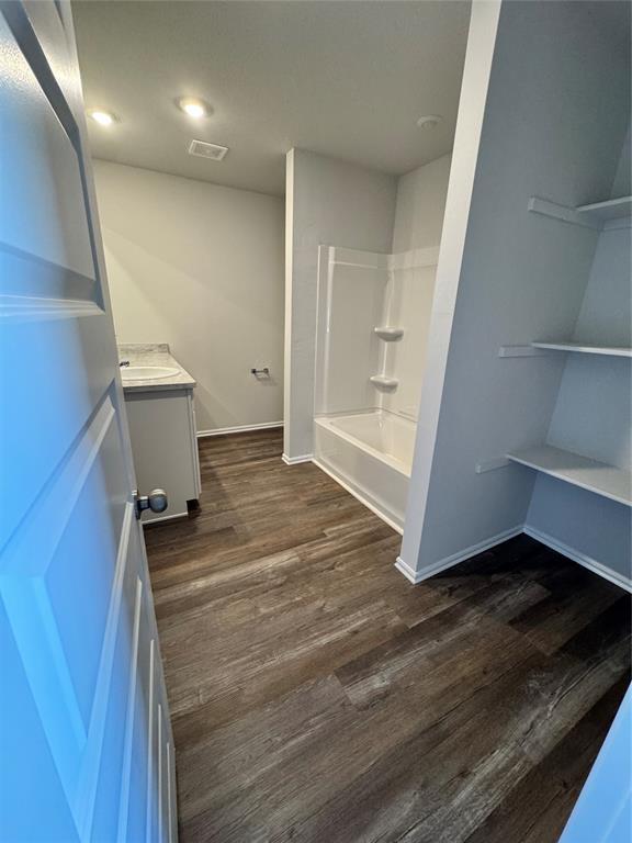437 Kale Rd, Tuttle, OK 73089 - full bathroom with vanity, wood finished floors, baseboards, and shower / tub combination