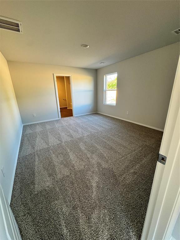 437 Kale Rd, Tuttle, OK 73089 - empty room featuring baseboards and carpet