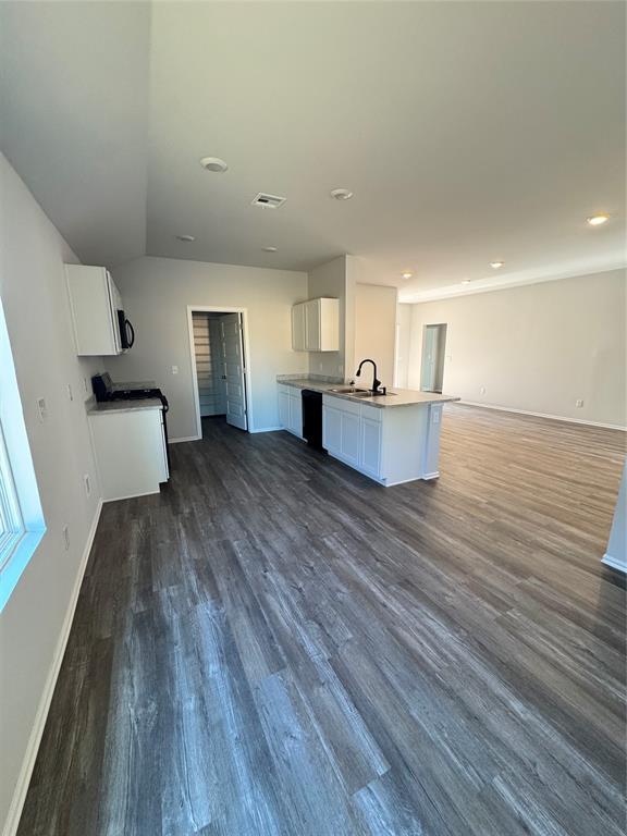 437 Kale Rd, Tuttle, OK 73089 - kitchen featuring open floor plan, white cabinets, dark wood-type flooring, baseboards, and a sink