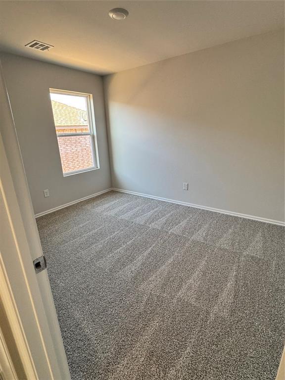 437 Kale Rd, Tuttle, OK 73089 - carpeted spare room with baseboards