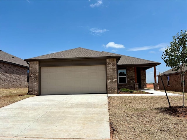424 Kale Rd, Tuttle, OK 73089 - view of front facade featuring brick siding, driveway, a garage, and roof with shingles