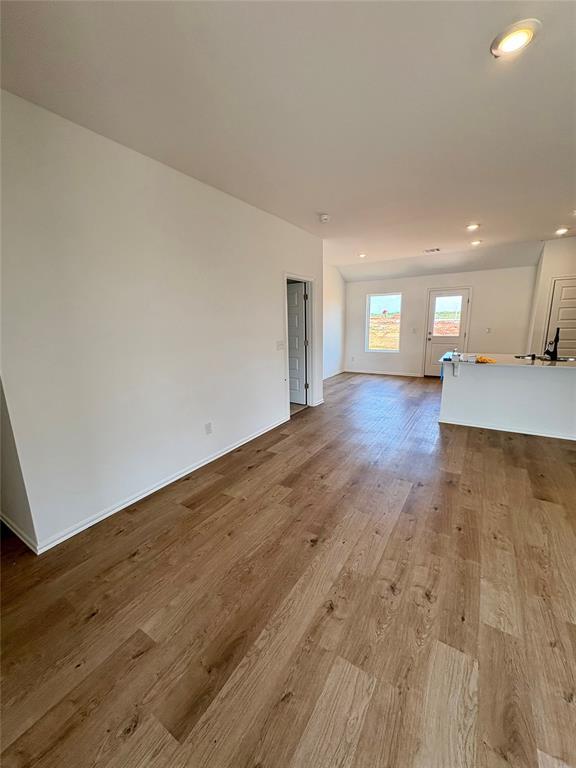 424 Kale Rd, Tuttle, OK 73089 - unfurnished living room featuring wood finished floors and recessed lighting