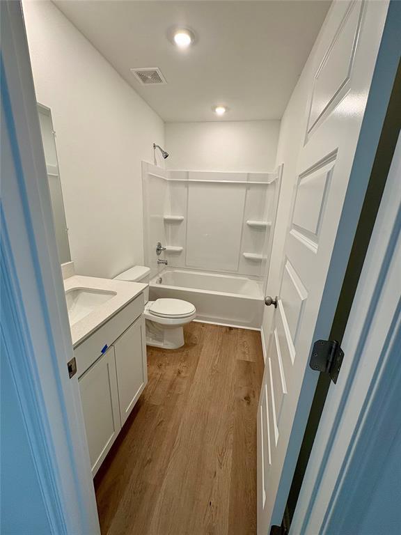 424 Kale Rd, Tuttle, OK 73089 - full bath with vanity, wood finished floors, and  shower combination