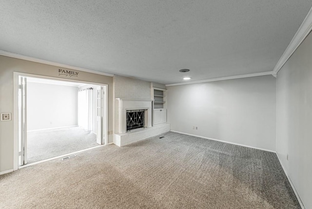 237 E 30th St, Edmond, OK 73013 - unfurnished living room featuring ornamental molding, carpet flooring, a fireplace with raised hearth, baseboards, and a textured ceiling