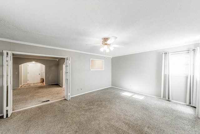 237 E 30th St, Edmond, OK 73013 - spare room with ceiling fan, crown molding, arched walkways, carpet floors, and a textured ceiling