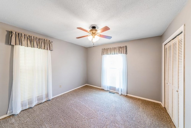 237 E 30th St, Edmond, OK 73013 - unfurnished bedroom featuring a closet, carpet flooring, baseboards, and a textured ceiling