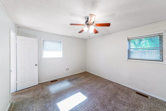 237 E 30th St, Edmond, OK 73013 - carpeted spare room with plenty of natural light, ceiling fan, a textured ceiling, and baseboards
