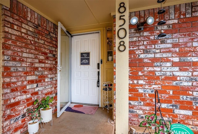 property entrance with brick siding