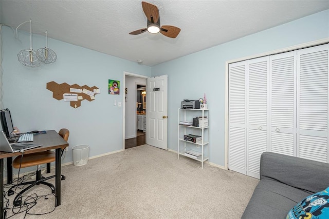 home office featuring carpet floors, baseboards, and ceiling fan
