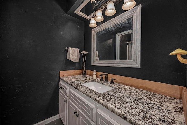 bathroom with vanity and a textured wall