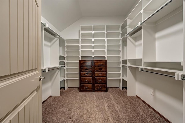 spacious closet featuring carpet floors and vaulted ceiling