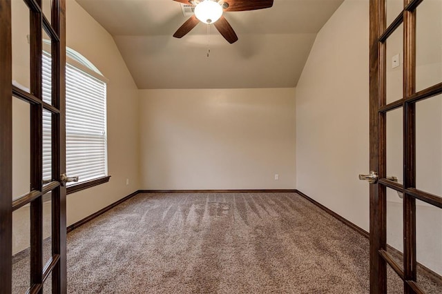 spare room featuring ceiling fan, carpet floors, french doors, and lofted ceiling