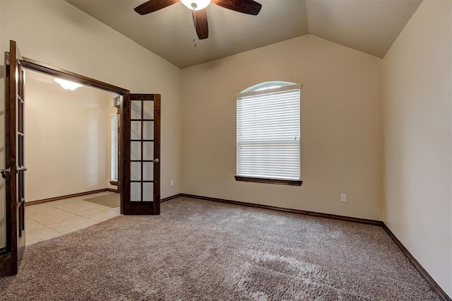 unfurnished room featuring lofted ceiling, french doors, a ceiling fan, and light carpet
