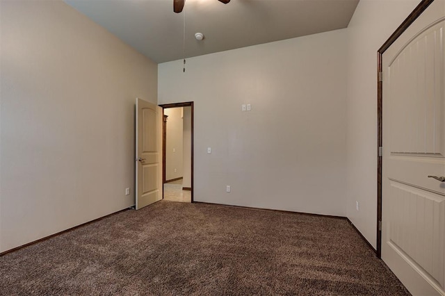 unfurnished room featuring light colored carpet and a ceiling fan