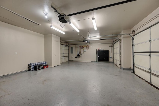 garage featuring electric panel and a garage door opener