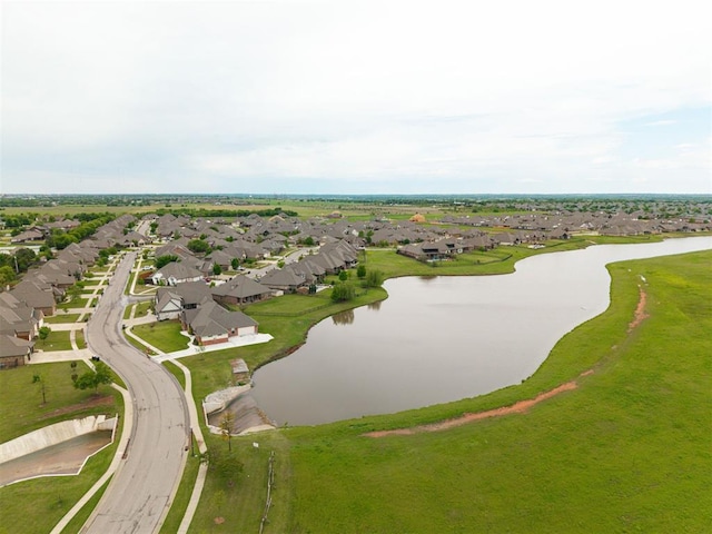 drone / aerial view with a water view and a residential view