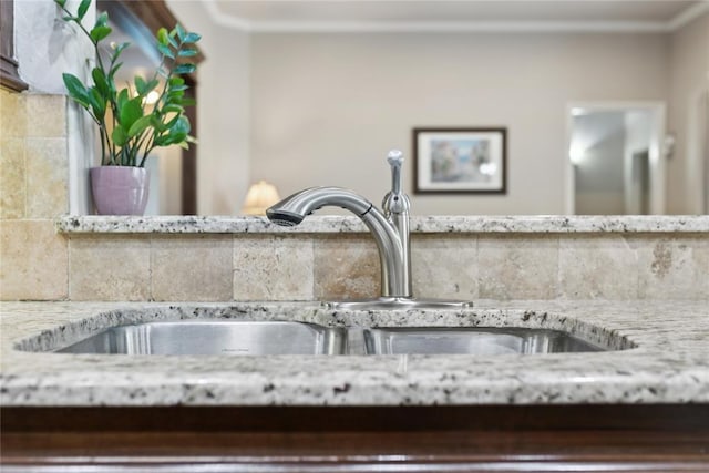 532 Conquistador Ct, Edmond, OK 73025 - details with decorative backsplash, ornamental molding, and a sink