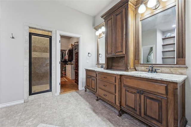 532 Conquistador Ct, Edmond, OK 73025 - bathroom featuring a spacious closet, a shower stall, double vanity, and a sink