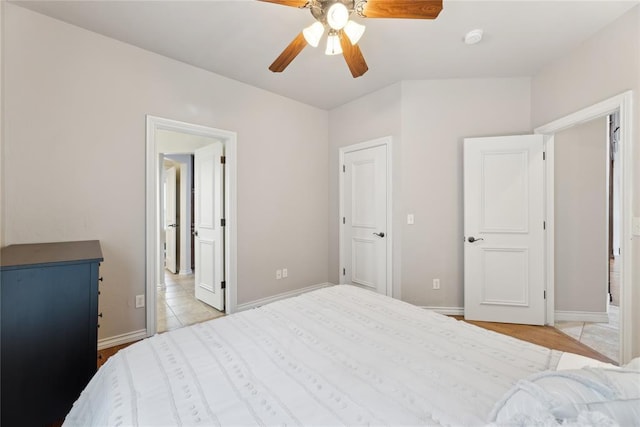532 Conquistador Ct, Edmond, OK 73025 - bedroom with light tile patterned flooring, ceiling fan, and baseboards