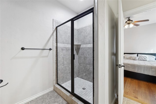 532 Conquistador Ct, Edmond, OK 73025 - bathroom with baseboards, a ceiling fan, a shower stall, and ensuite bathroom