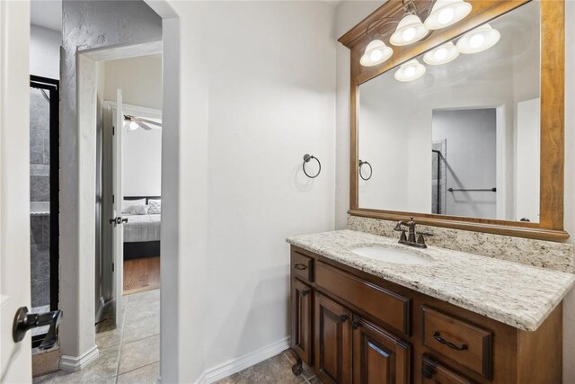 532 Conquistador Ct, Edmond, OK 73025 - ensuite bathroom featuring ensuite bath, tile patterned floors, vanity, baseboards, and a ceiling fan