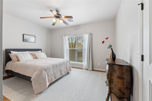 532 Conquistador Ct, Edmond, OK 73025 - bedroom featuring visible vents, light wood-style floors, a ceiling fan, and baseboards