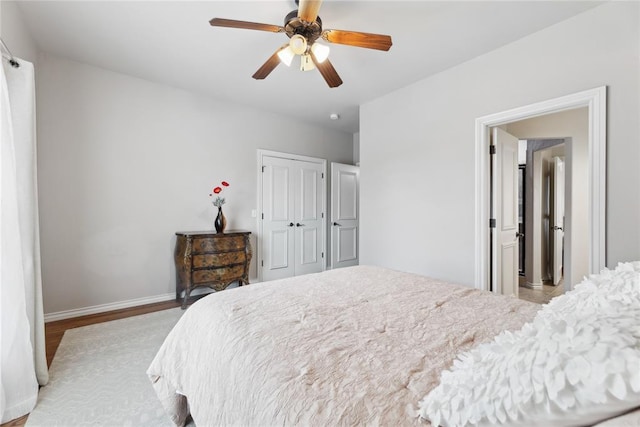 532 Conquistador Ct, Edmond, OK 73025 - bedroom featuring a closet, ceiling fan, wood finished floors, and baseboards