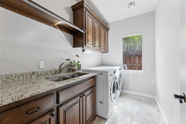 532 Conquistador Ct, Edmond, OK 73025 - laundry area featuring washing machine and dryer, a sink, visible vents, baseboards, and cabinet space