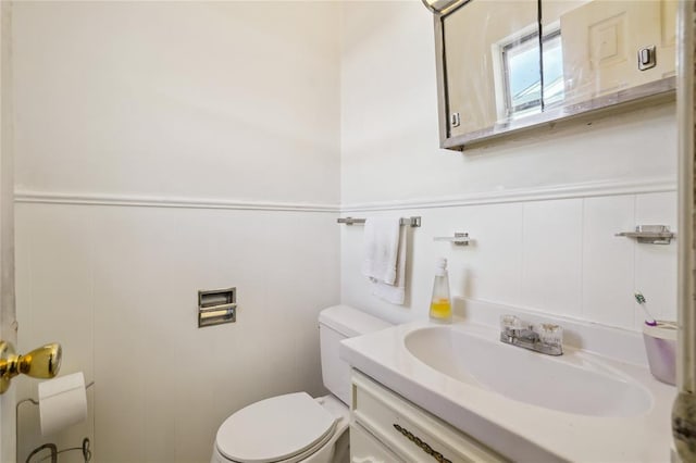 1305 Juniper Cir, Oklahoma City, OK 73110 - half bath with vanity, a wainscoted wall, and toilet