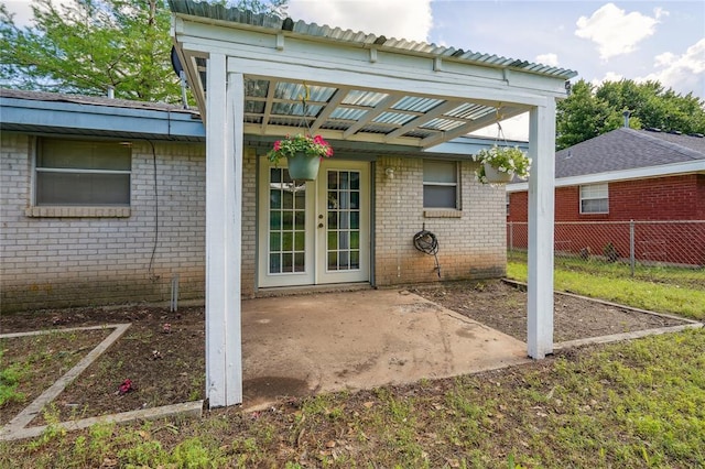 1305 Juniper Cir, Oklahoma City, OK 73110 - back of property with brick siding, fence, french doors, and a patio