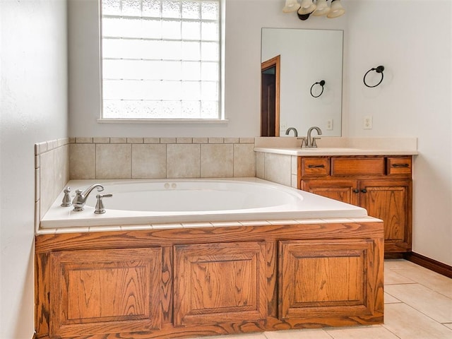 bathroom with a sink, tile patterned flooring, and a garden tub