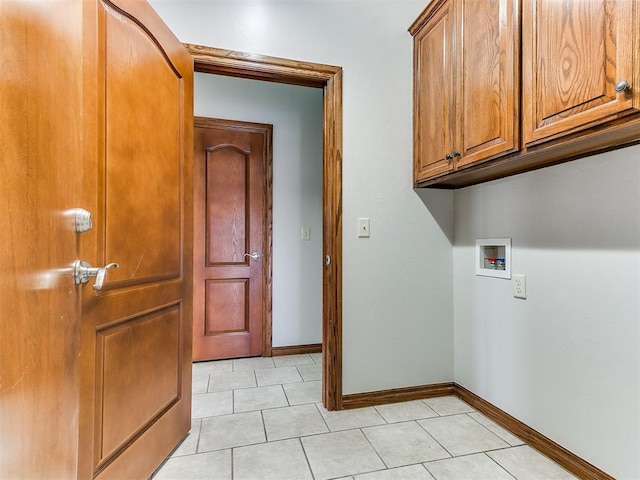 laundry area with cabinet space, light tile patterned floors, washer hookup, and baseboards