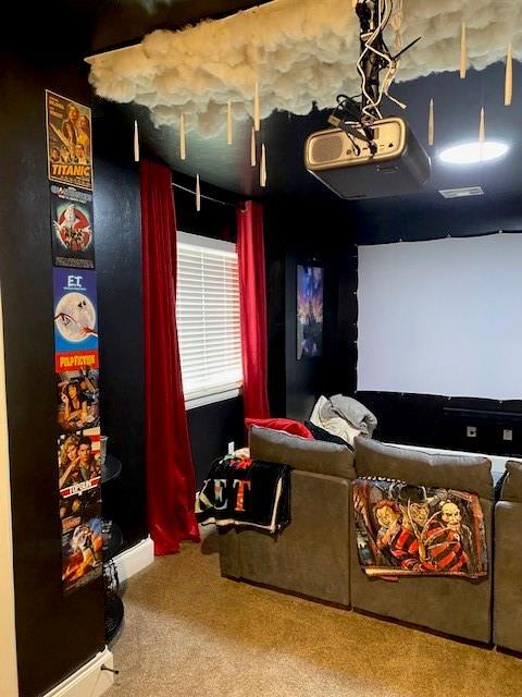 carpeted home theater featuring visible vents