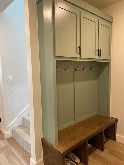 mudroom featuring light wood-style flooring and baseboards